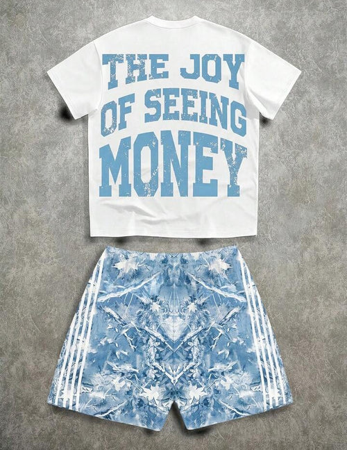 White t-shirt with 'The Joy of Seeing Money' text and blue patterned shorts on a gray background